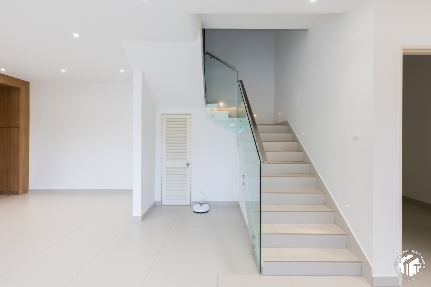 Minimalist glass staircase with under-stair storage